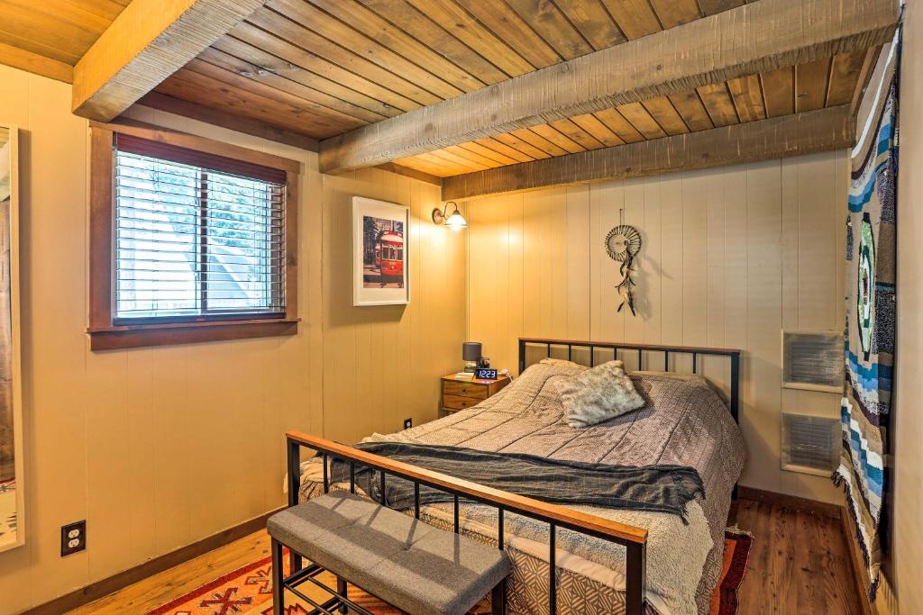 a bedroom with a bed and a bench in it at Running Springs A-Frame with Deck and Mtn Views! in Running Springs