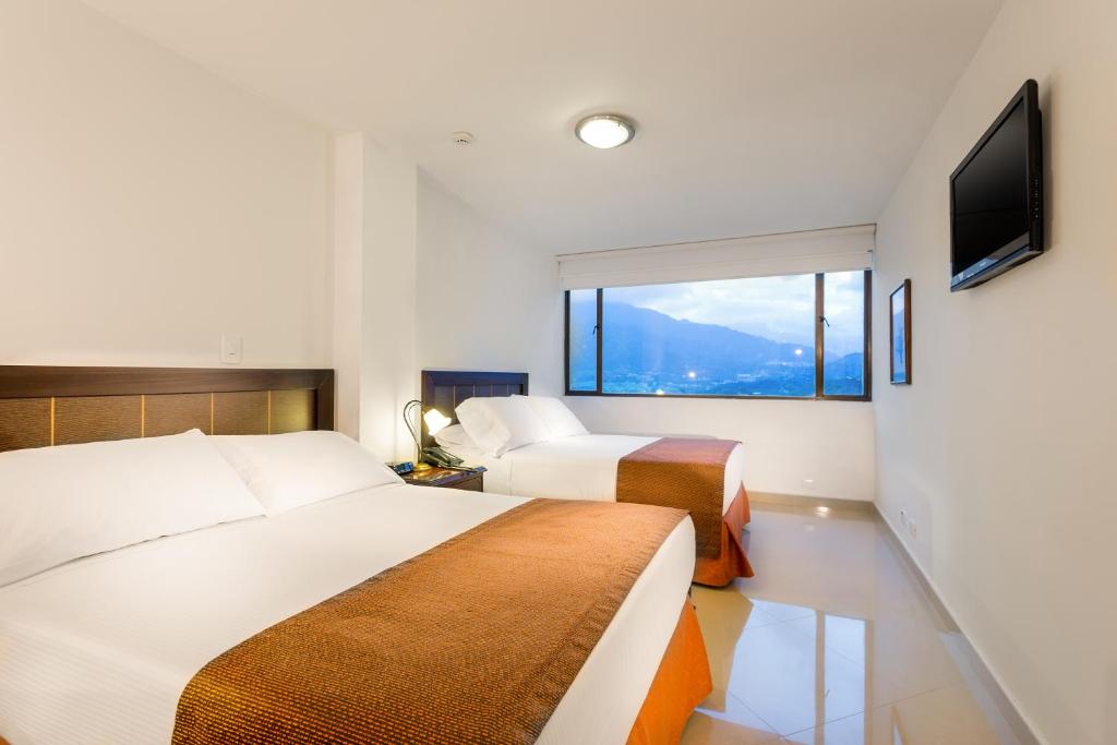 Postel nebo postele na pokoji v ubytování Hotel Dann Combeima