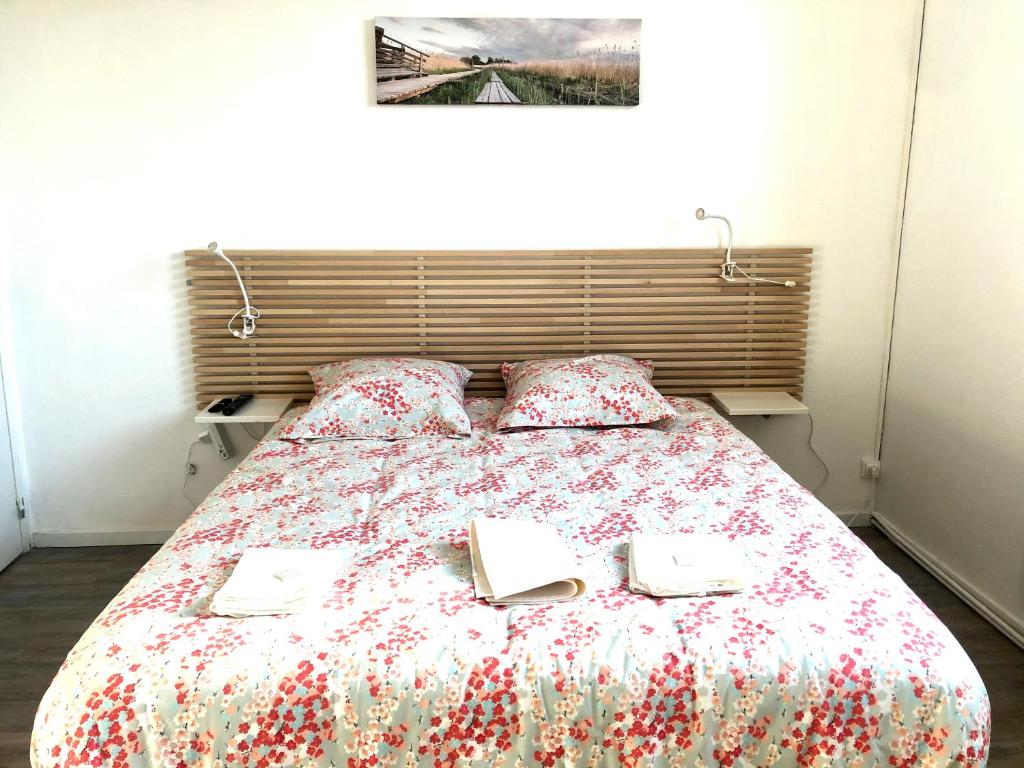 a bedroom with a bed with two books on it at Libourne centre in Libourne