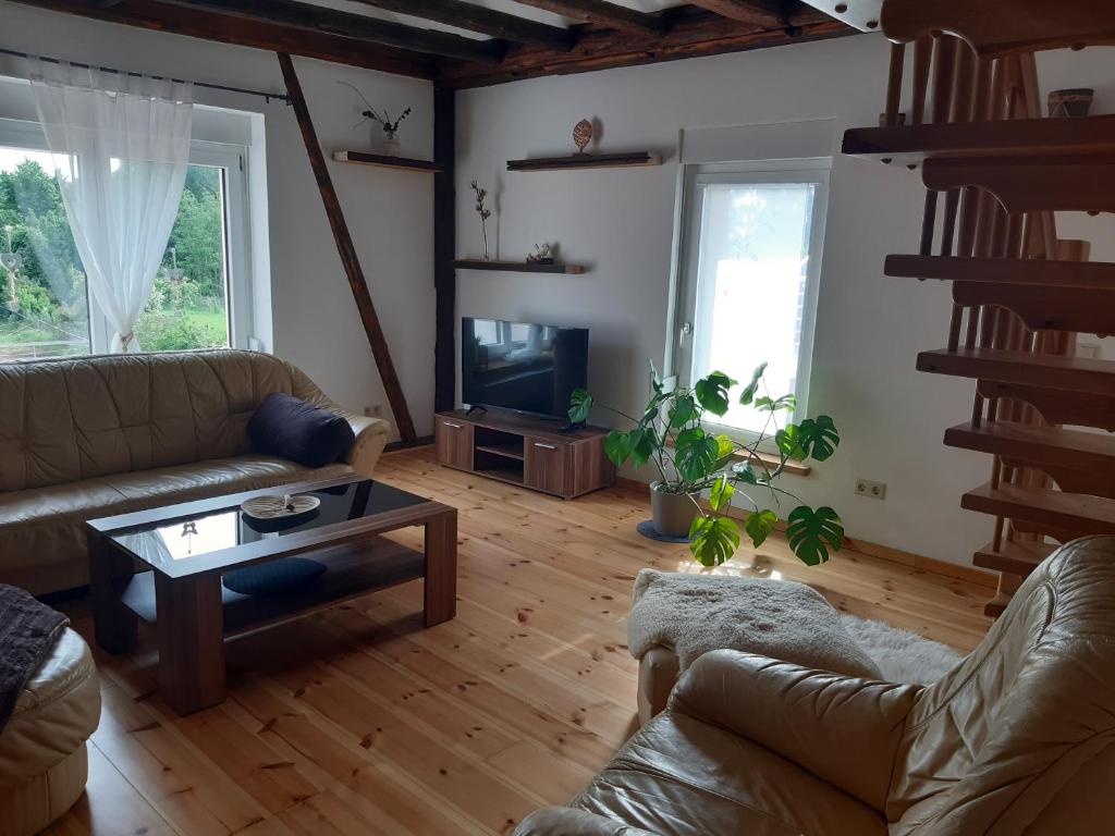 a living room with a couch and a coffee table at Ferienwohnung Alte Molkerei in Bad Sulza