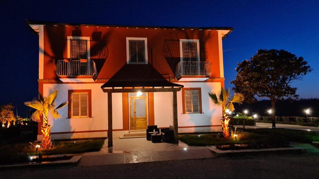 a house with a gazebo in front of it at night at Agriturismo il Casale in Ponte Galeria