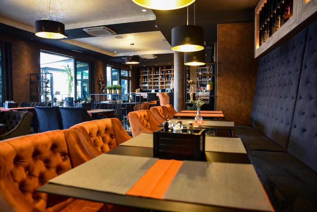 a restaurant with tables and chairs in a room at Hotel Meduza in Senj