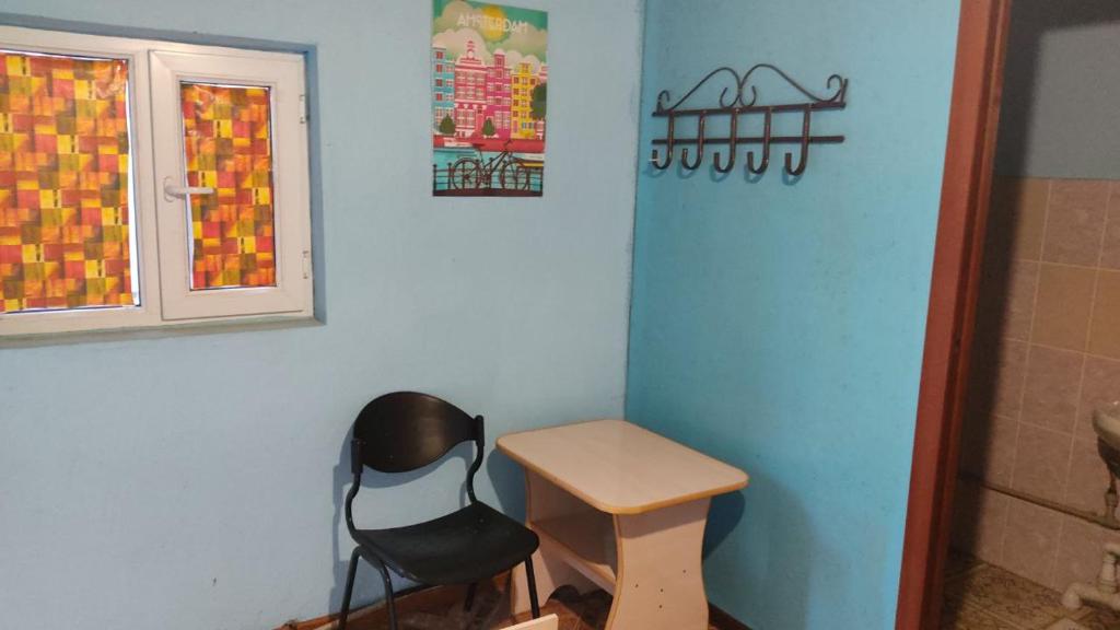 a room with a chair and a table and a window at Отдых в Капшагае! in Kapchagay