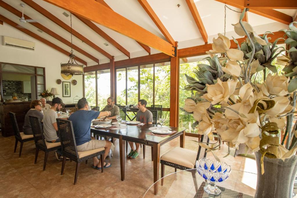 a group of people sitting around a dining room table at Rancho Humo Estancia in Puerto Humo