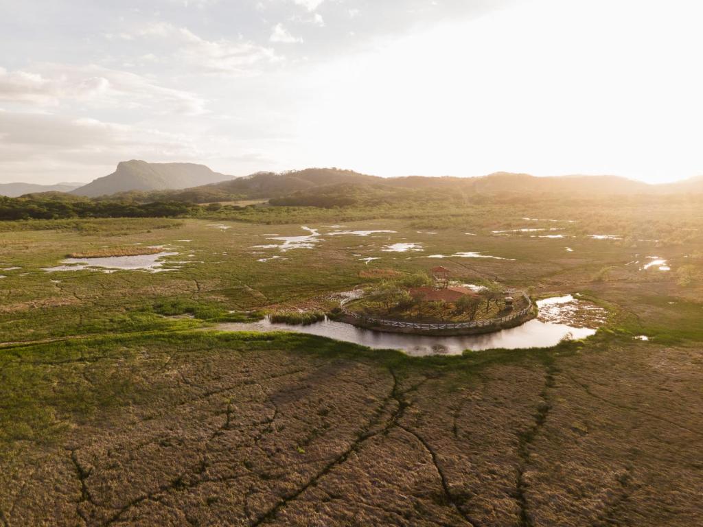 an aerial view of a river in a field at Rancho Humo Estancia in Puerto Humo