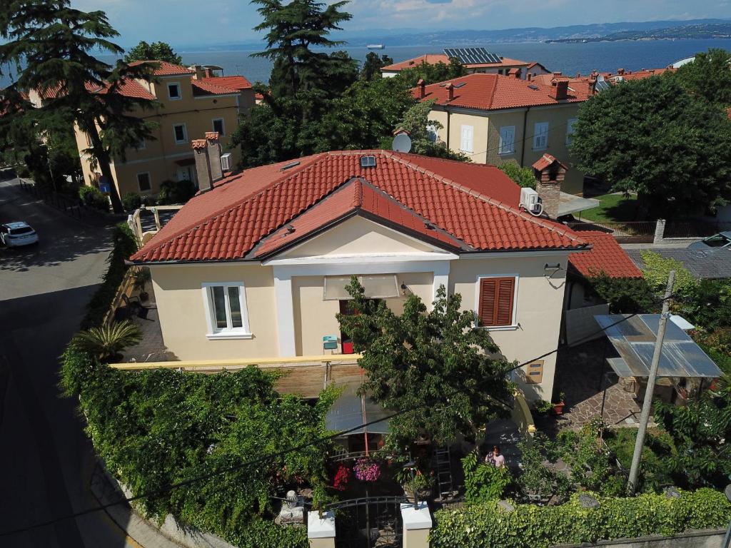 a white house with a red roof at Apartments Villa Sandi in Izola