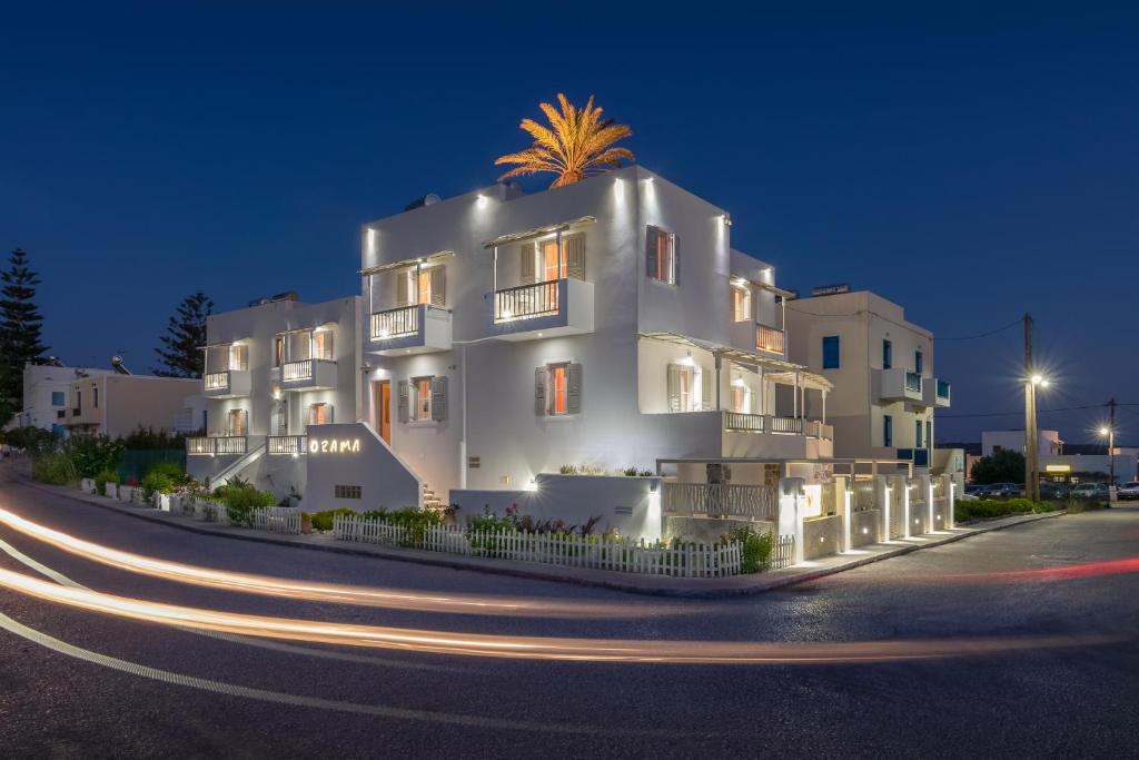 a white building with a palm tree on top of it at Orama Milos in Adamantas