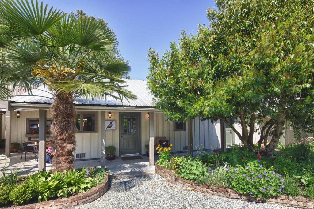 a house with palm trees in front of it at Hedgerow House in Ganges