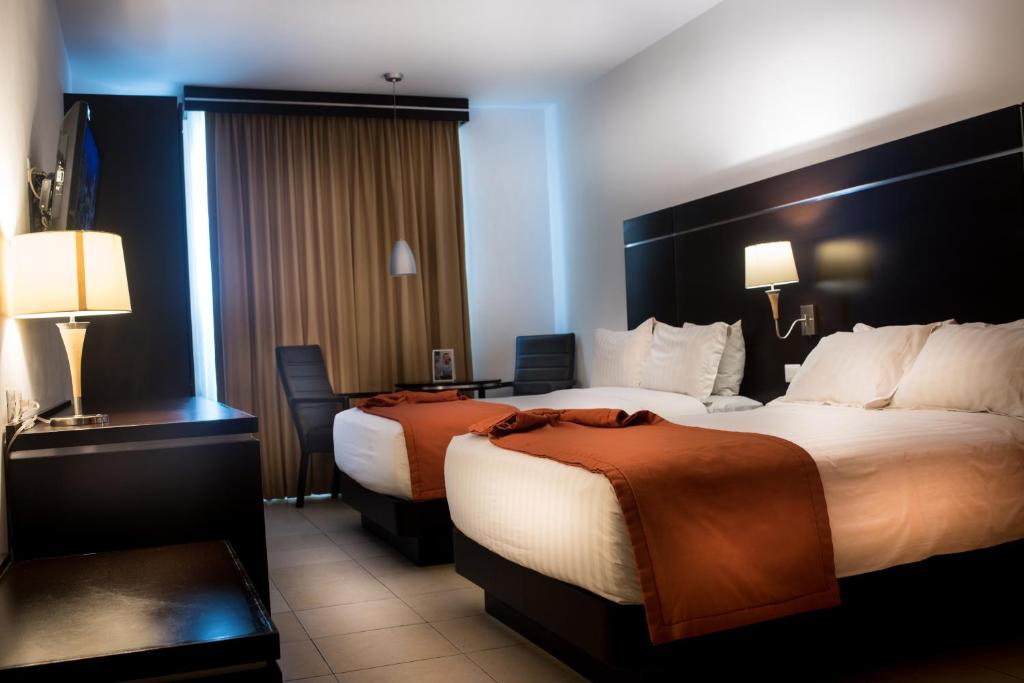 Postel nebo postele na pokoji v ubytování HOTEL OLIBA Boca del Rio