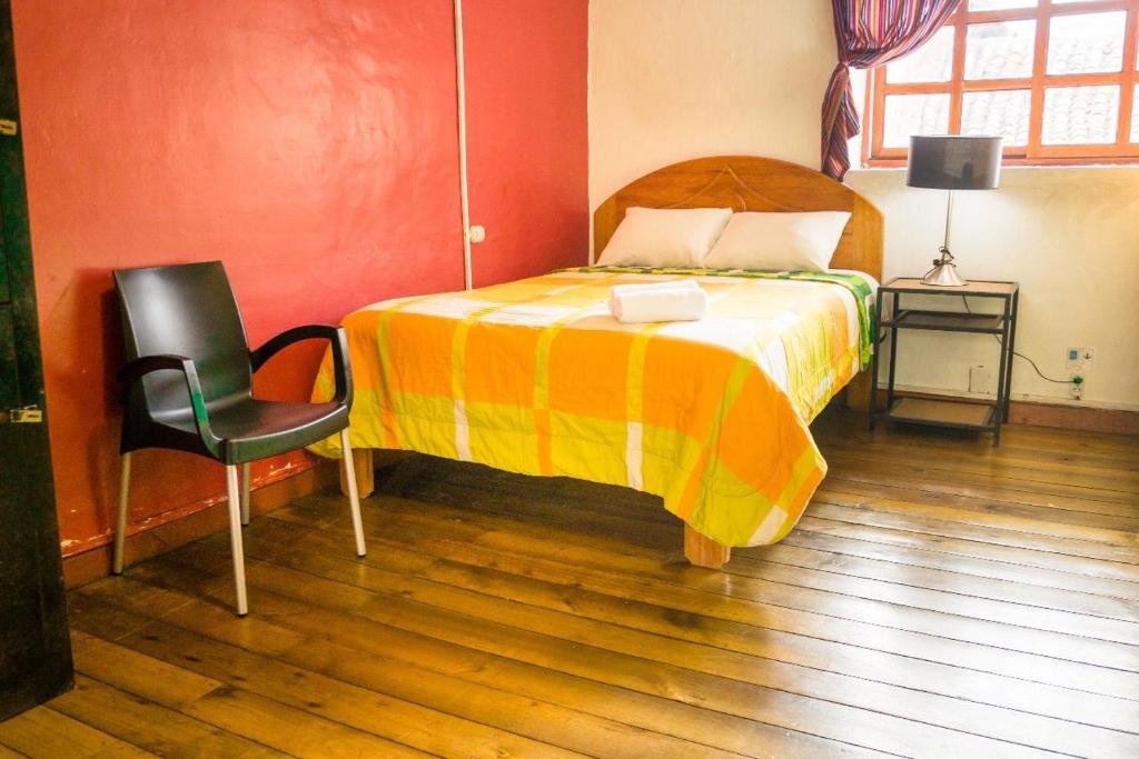 מיטה או מיטות בחדר ב-Dragonfly Hostels Cusco