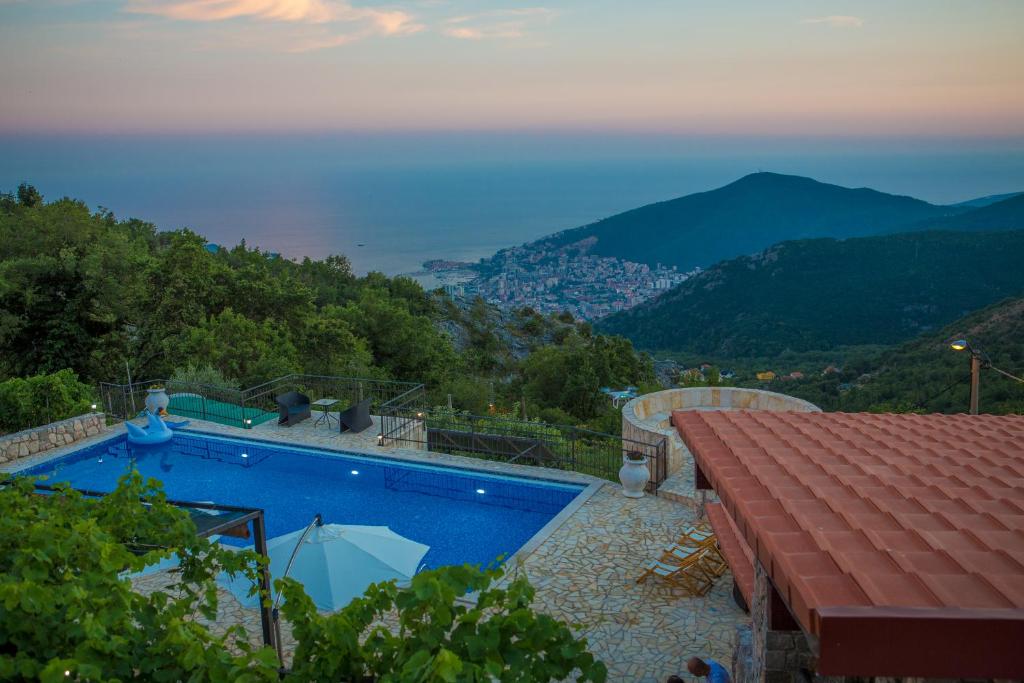 a swimming pool with a view of the mountains at Villa Marija **** with private pool in Budva