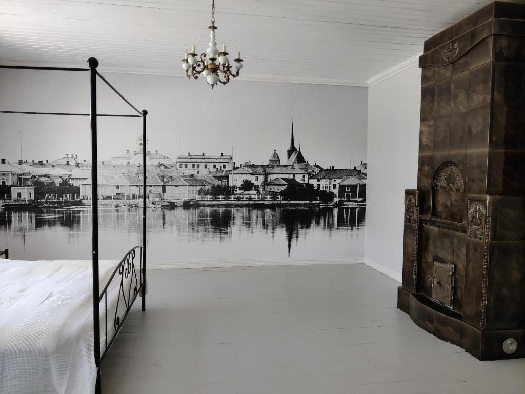 a bedroom with a bed and a view of a river at Willa Viktor in Kristinestad