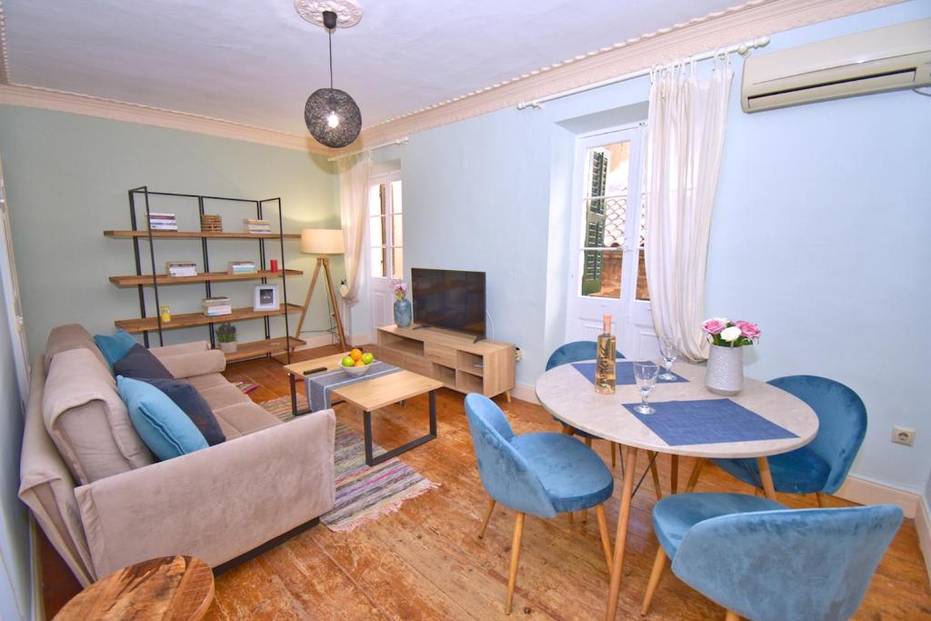 a living room with a couch and a table at Roses Apartment in Corfu city centre in Corfu Town