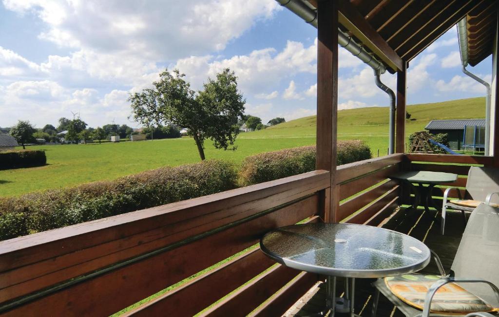 a porch with a table and chairs and a field at Nice Apartment In Fleringen With Wifi in Fleringen