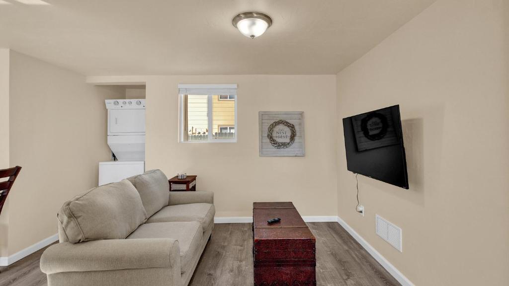 a living room with a couch and a table at Your Nest Away from Home in Colorado Springs