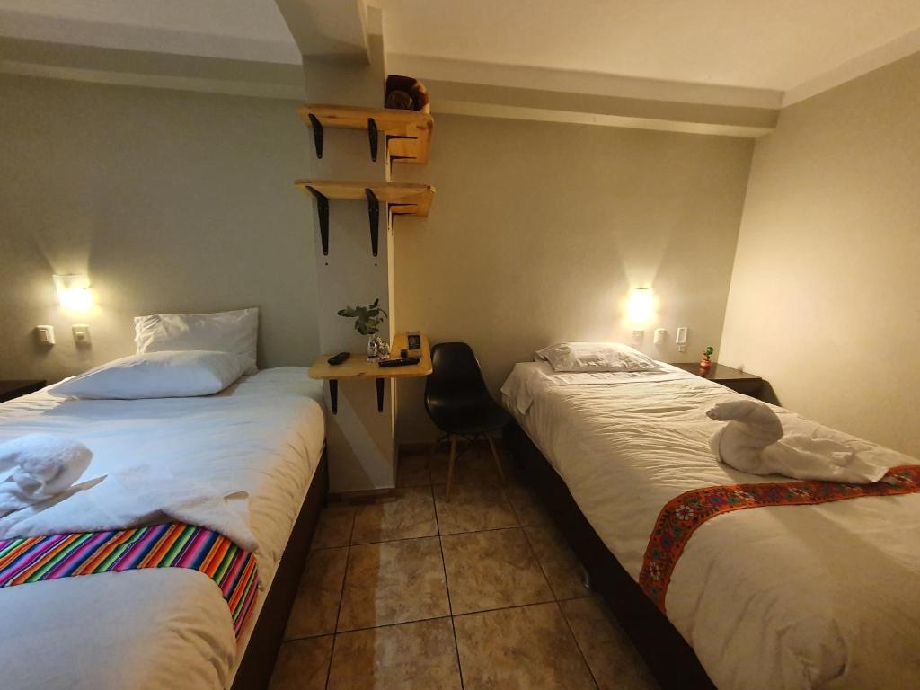 Postel nebo postele na pokoji v ubytování RUMIQOLQA Machupicchu Hotel