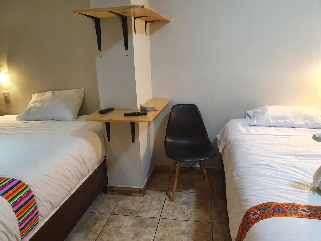Postel nebo postele na pokoji v ubytování RUMIQOLQA Machupicchu Hotel