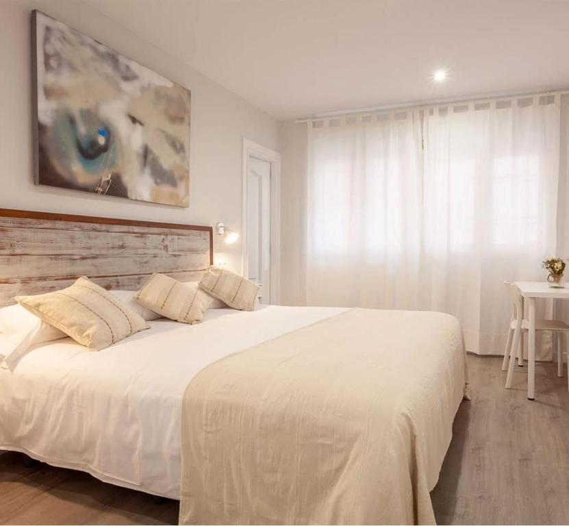 a bedroom with a large white bed in a room at Hotel Prada. in Gijón