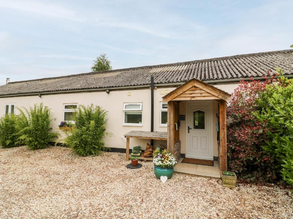 a detached house with a garden in front of it at Willow Lodge in Brough