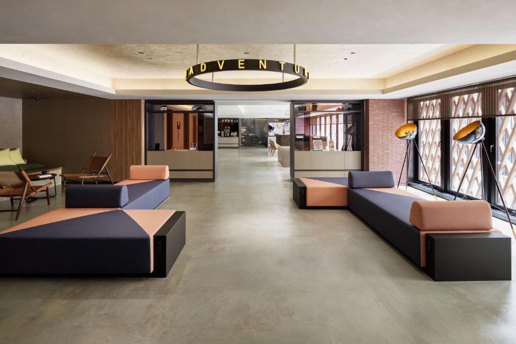 a lobby with couches and a sign that reads luxury at the b ginza in Tokyo