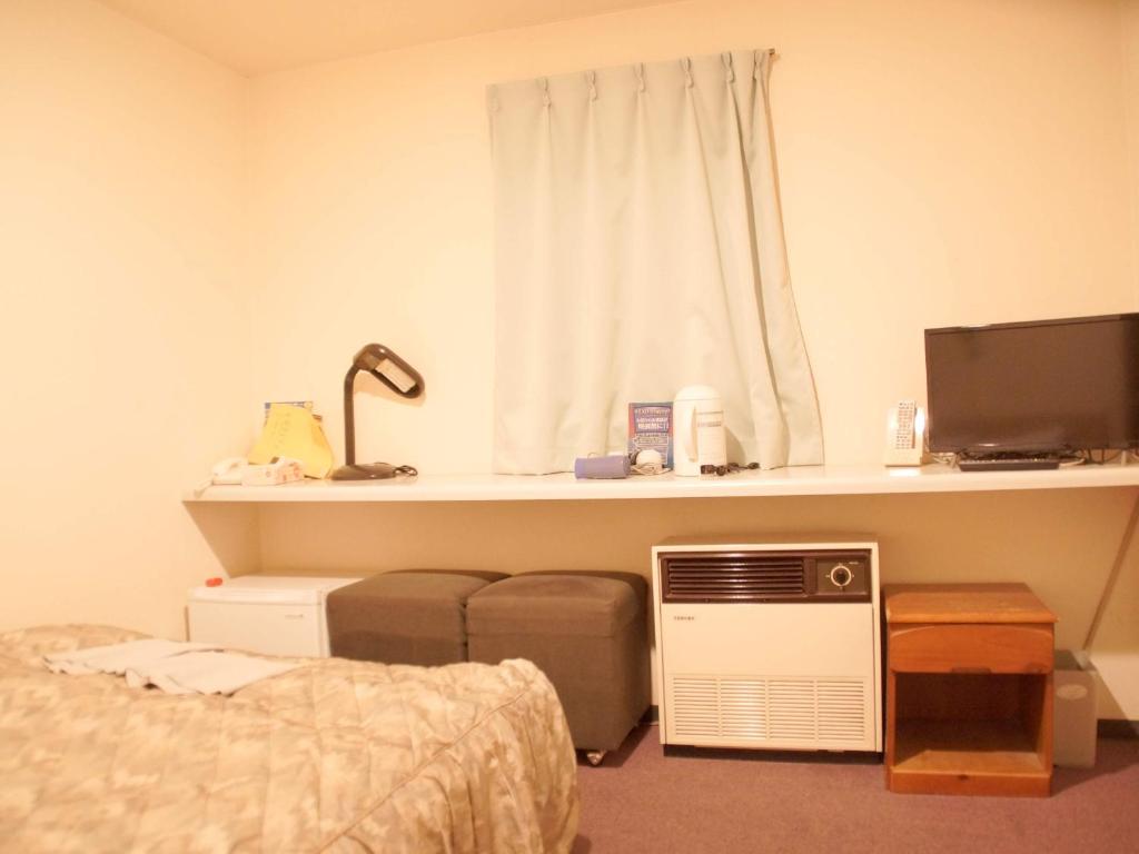 Postel nebo postele na pokoji v ubytování Business Hotel Chateau Est Takamatsu