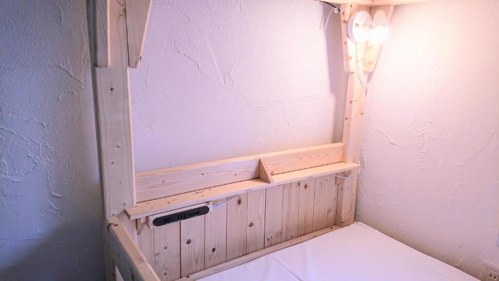 Postel nebo postele na pokoji v ubytování Kawayu Onsen Guesthouse NOMY