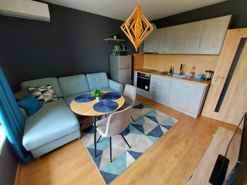 a living room with a table and a couch at GREY Apartment in Varna City