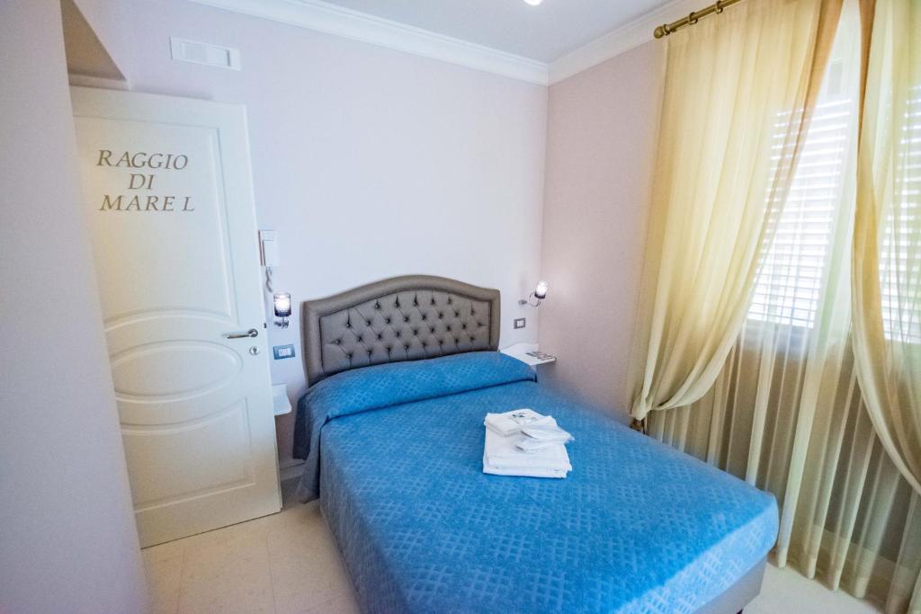 a bedroom with a bed with a blue bedspread at Sogno D'Epoca 1822 in Monopoli