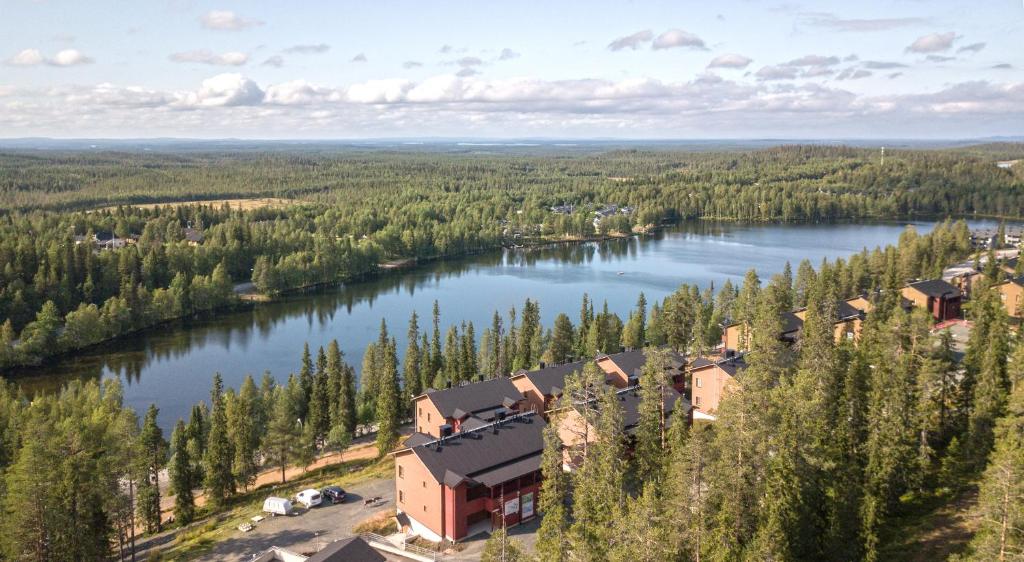 an aerial view of a building next to a lake at Ski-Inn AurinkoRinne in Ruka