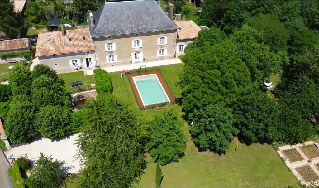 an aerial view of a house with a swimming pool in the yard at Le Logis de Limalonges in Limalonges