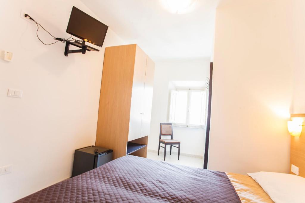 Postel nebo postele na pokoji v ubytování Hotel Rex