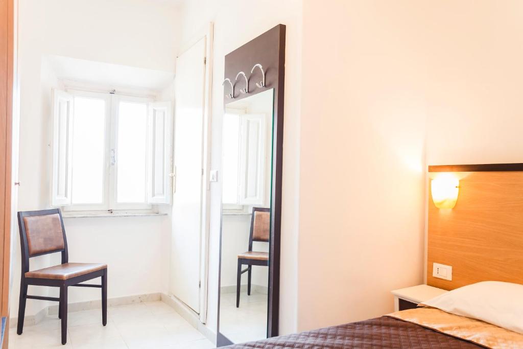 Postel nebo postele na pokoji v ubytování Hotel Rex