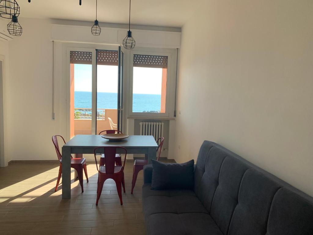 a living room with a couch and a table at Appartamento fronte mare in Porto Recanati