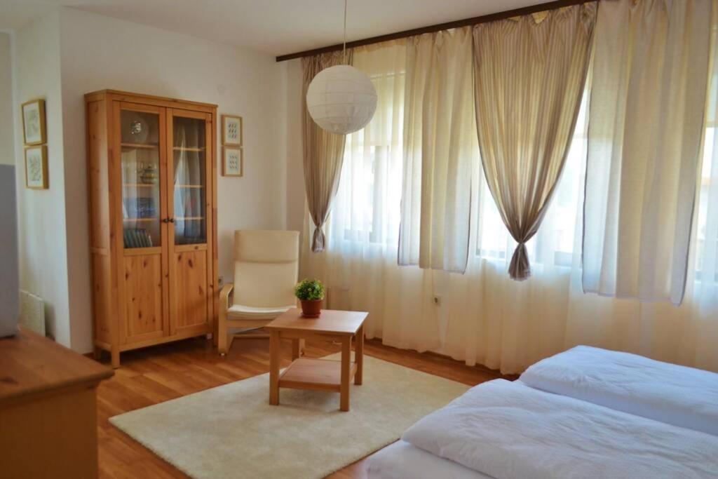 a bedroom with a bed and a table and a chair at Просторная студия в жилом комплексе Hill Top in Bansko