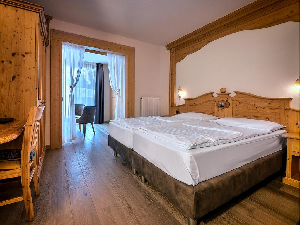 Postel nebo postele na pokoji v ubytování Hotel Madonna delle Nevi