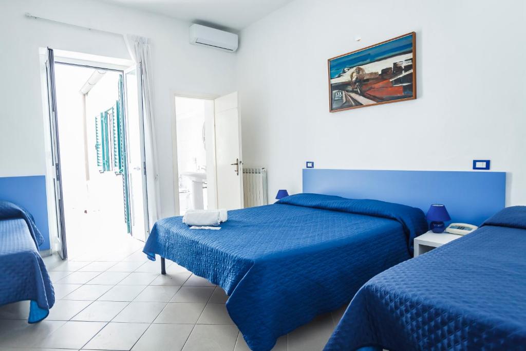 Postel nebo postele na pokoji v ubytování Hotel Rex
