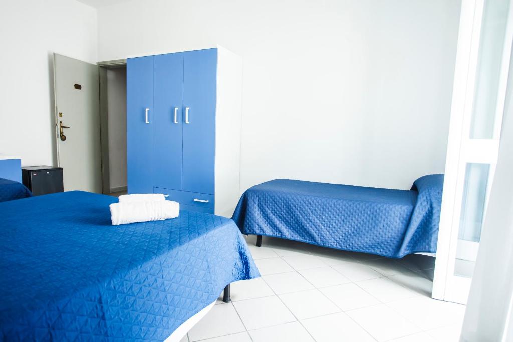 Postel nebo postele na pokoji v ubytování Hotel Rex