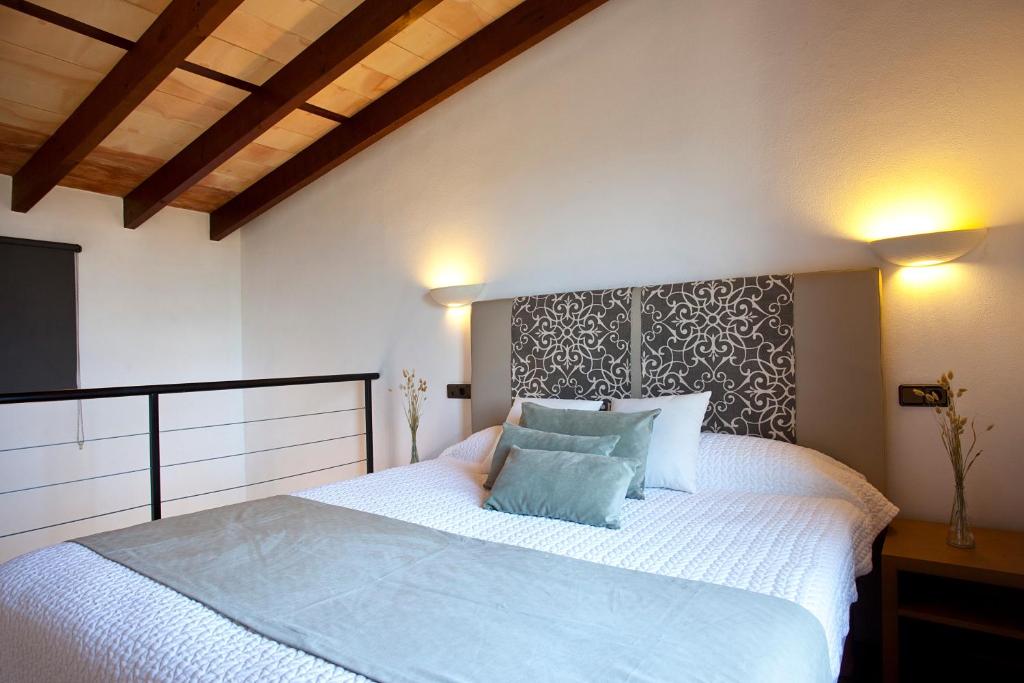 A bed or beds in a room at S'Hort de Son Caulelles - Adults Only