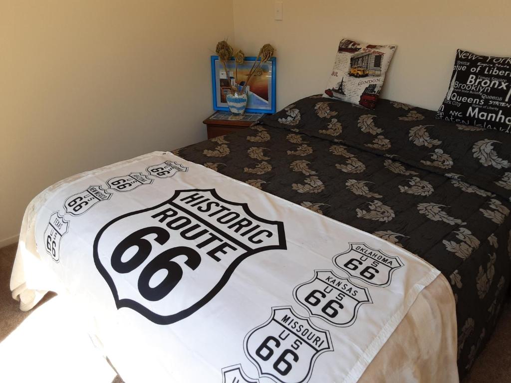 a bedroom with a bed with a patriots blanket at I'm a traveller in Dunedin