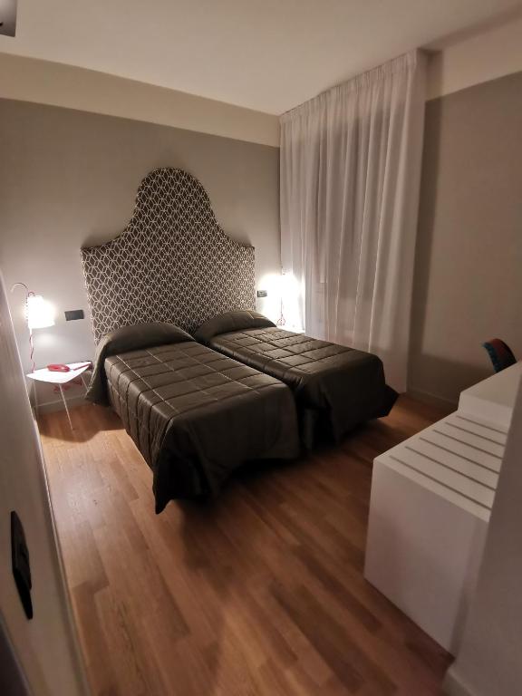 Postel nebo postele na pokoji v ubytování Hotel Moderno