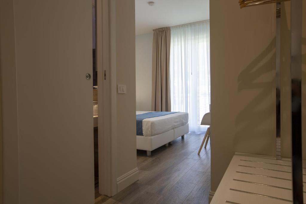 a bedroom with a bed and a window at Luxmarì Hotel & Spa in Castellammare del Golfo