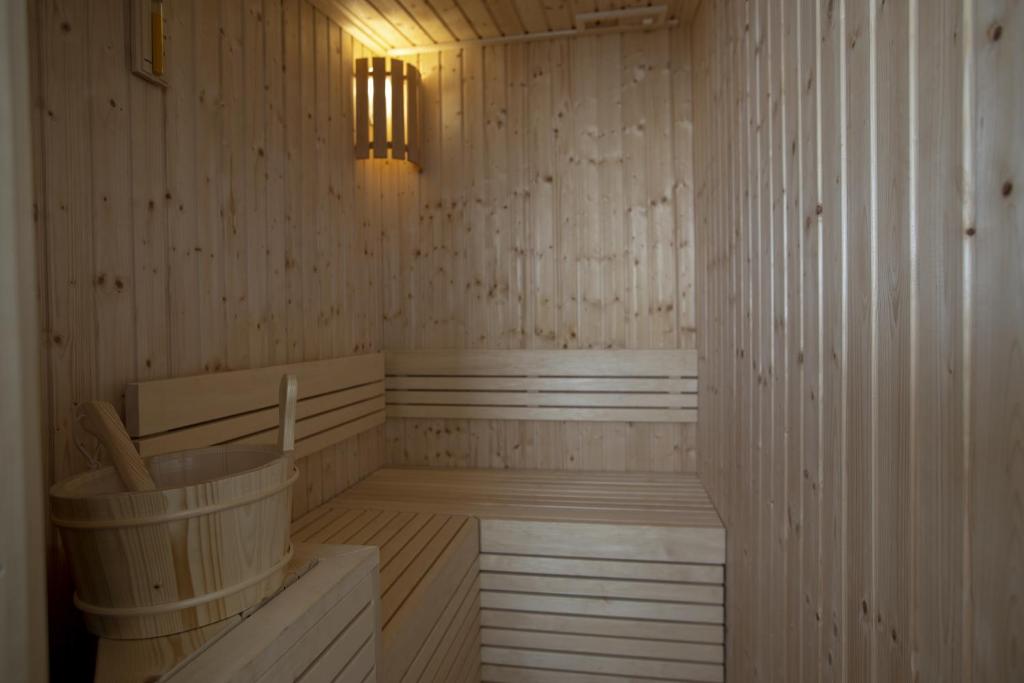 a wooden sauna with a tub and a light at Luxmarì Hotel & Spa in Castellammare del Golfo