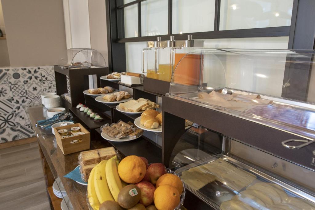 a buffet line with many different types of food at Luxmarì Hotel & Spa in Castellammare del Golfo
