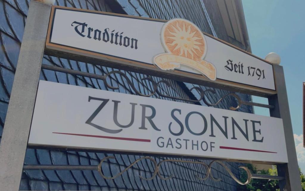a sign for a zur some classifier on a building at Hotel Zur Sonne in Kirchhain