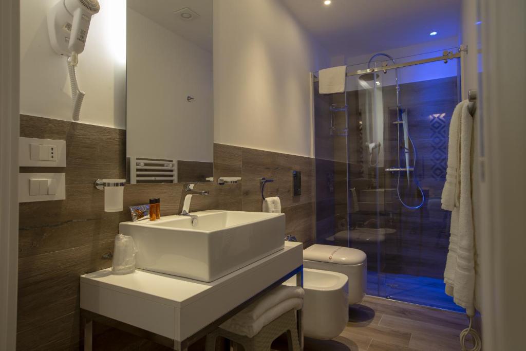 a bathroom with a sink and a shower at Luxmarì Hotel & Spa in Castellammare del Golfo