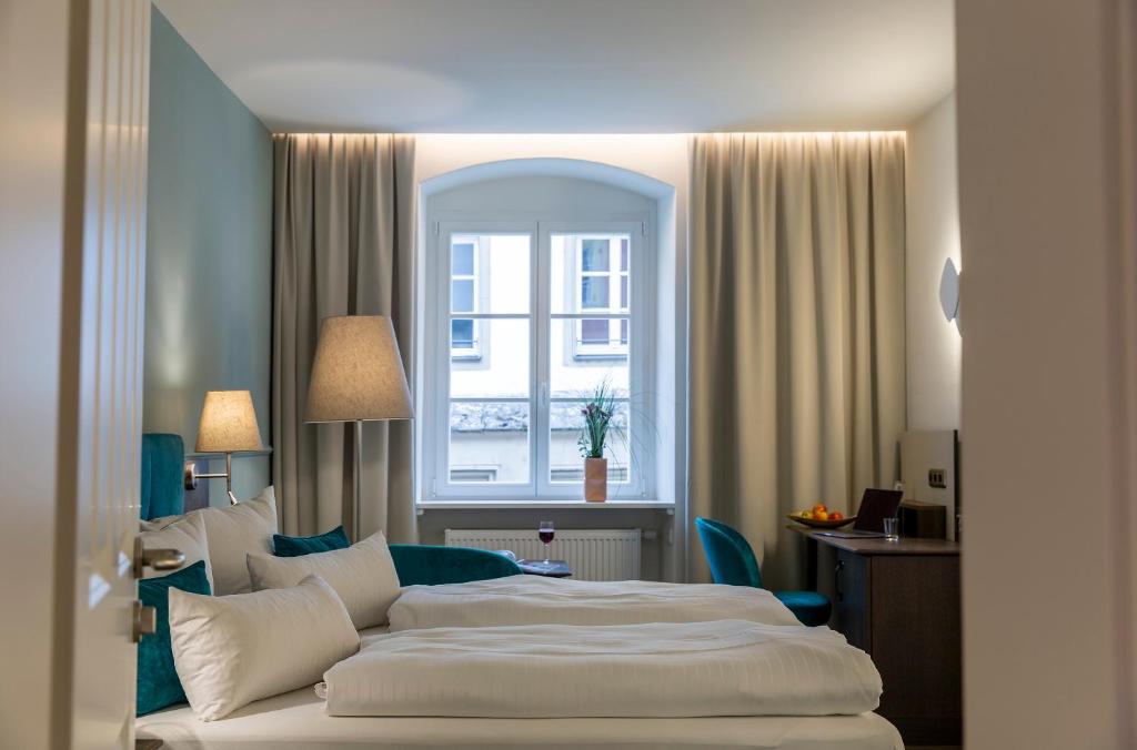Postel nebo postele na pokoji v ubytování Altstadthotel der Patrizier