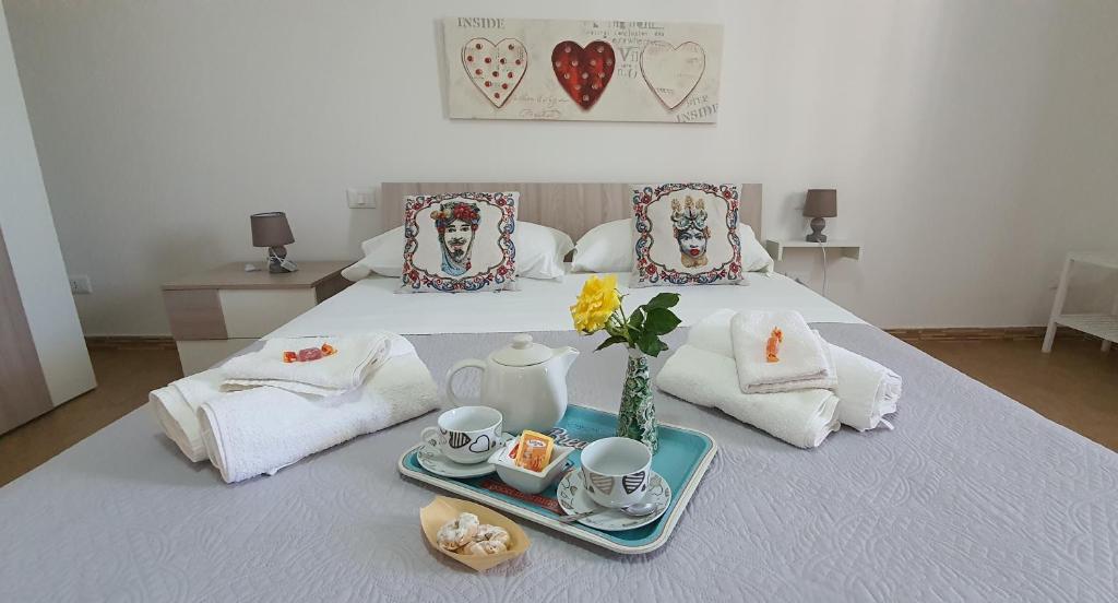a bedroom with a bed with a tray of tea sets at A Casa Di Coso B&B in Marsala