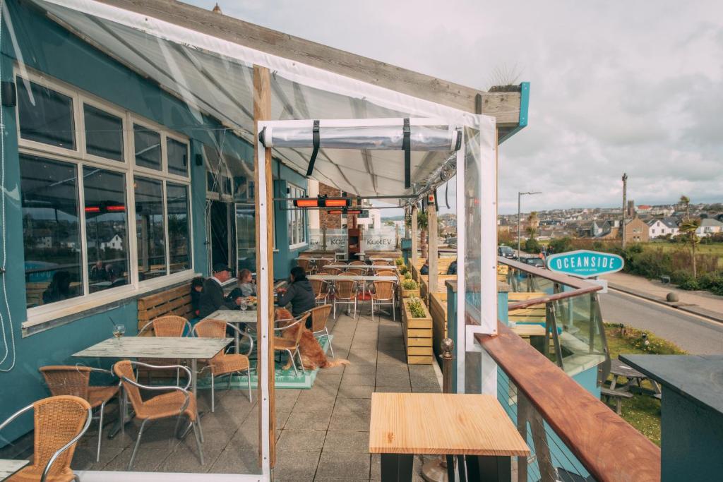 a patio of a restaurant with tables and chairs at Oceanside Lifestyle Hotel in Newquay