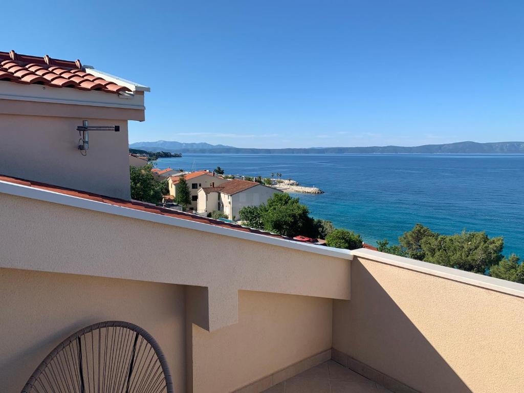 a view of the ocean from the balcony of a building at Apartments Nevenka i Josko in Tučepi