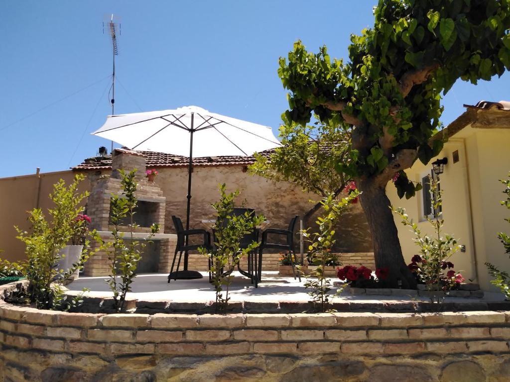 a patio with an umbrella in front of a house at Casa Bellissima in Chania